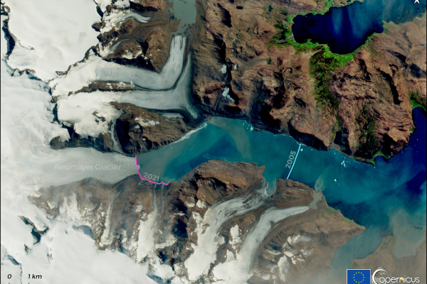 OBSERVER: Celebrating nine years of Copernicus Sentinel-2A The image is a Sentinel-2 satellite view from 22 January 2021, showing the Neumayer Glacier in South Georgia, one of the largest tidewater glaciers. The glacier terminus in 2021 is marked with a magenta line, while the terminus in April 2005, captured by a Landsat-8 image, is marked with a cyan line. The comparison indicates that the glacier has shrunk by more than 8 km over 16 years. The image highlights the glacier's retreat, with snow-covered areas, rocky terrain, and surrounding water bodies clearly vis